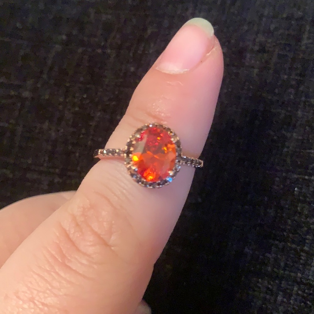 Rose gold metal band with orange stone